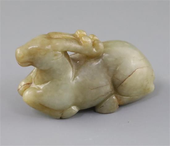 A Chinese pale celadon and russet jade figure of a recumbent stag, 19th century, L.8.7cm